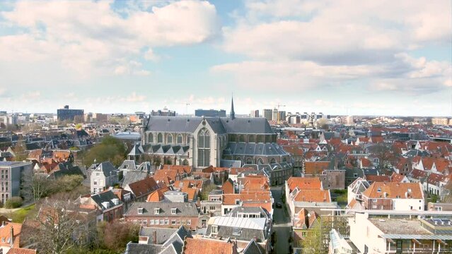 Aerial shot flying high over the historical city centre of Leiden, the Netherlands, with the Pieterskerk, Leiden University and Rapenburg canal