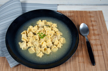 close up view of delicious agnoline in black  bowl 