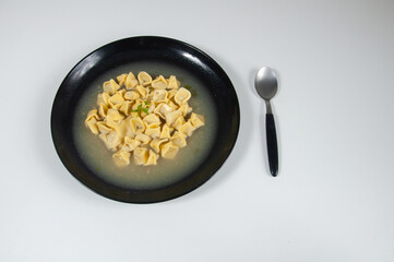close up view of delicious agnoline in black  bowl 