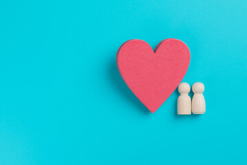 a red heart made of wooden planks placed on a blue background,