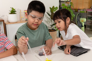 Asian kids do chemical experiments in their home