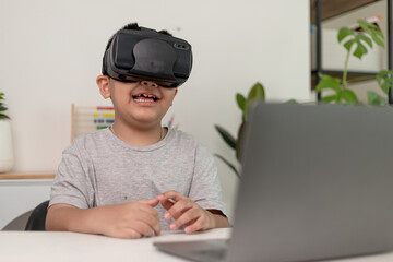 Asian Little boy with VR glasses studying sciences at home,curious student wears a virtual reality...