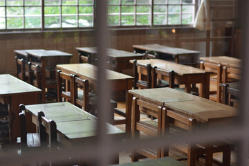 窓から光が射しこむ日本の古い小学校の教室