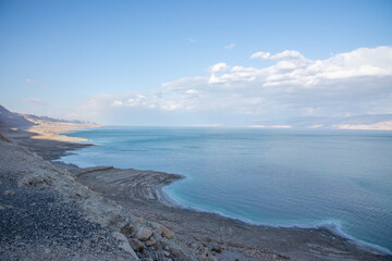 Exotic view of the sinkhole area of the Dead Sea. Salt crystals at sunset. The texture of the Dead sea. Salty seashore. High quality photo