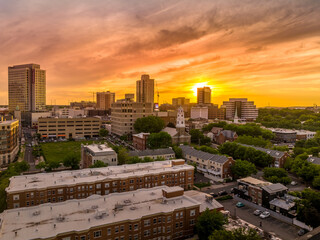 Aerial view of downtown New Brunswick, New Jersey with dramatic colorful sunset sky low rise...