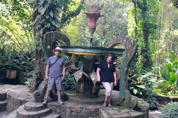 Naklejka na ściany i meble Couple of Latin man and woman walk and discover the magical town Χilitla in San Luis Potosí Mexico, they explore as tourists among the forest 