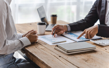 Business team of employees meeting, analyzing project document text, reports, marketing charts with sticky notes, planning work process, discussing papers, doing paperwork research. Close up of hands