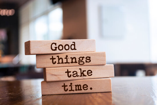 Naklejki Wooden blocks with words 'Good things take time'.