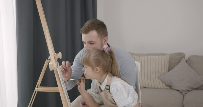 Father and daughter with down syndrome drawing together