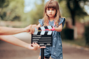 Toddler Girl on a Scooter Acting in Front of the Camera. Little child star playing in a commercial...