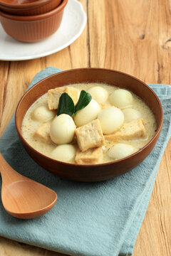 Opor Tahu Telur Puyuh or Indonesian Curry with Tofu and Quail Egg, Served on Ceramic Bowl