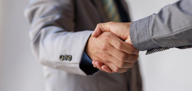 Business handshake for teamwork of business merger and acquisition,successful negotiate,hand shake,two businessman shake hand with partner to celebration partnership and business deal concept