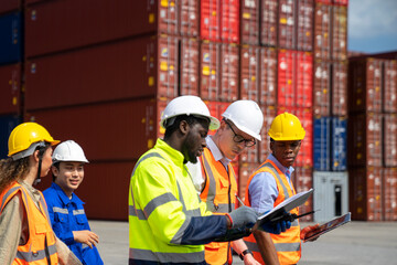 Group of engineer worker and manager standing in the shipping yard container.