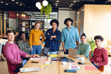 Portrait of confident multiracial design professionals in creative office