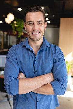 Portrait of smiling young caucasian creative businessman in office