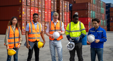 Group of engineer worker and manager standing in the shipping yard container.