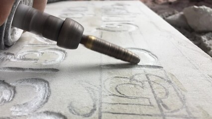 Close up video of Stone Carving, Letter Engraving - Powered by Adobe