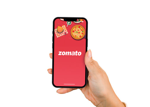 Female hand holding a smartphone iPhone with Zomato food delivery app app on the screen. White background. Rio de Janeiro, RJ, Brazil. July 2022