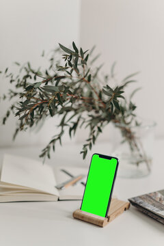 Touchscreen phone with a green screen stand