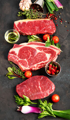 Variety of raw beef meat steaks for grilling.
