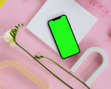 Top view of a new modern smartphone with green screen