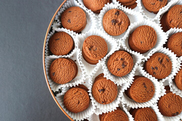 An overhead or flat lay view of Danish butter cookies in the traditional tin box. It's a Denmark delicacy consisting of butter, flour, and sugar. Danish chocolate chip biscuits. Copy space.
