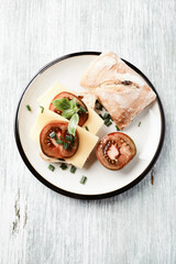 Sandwich with cheese and tomatoes. Bright wooden background. Top view. Copy space.