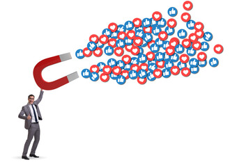 Businessman attracting likes with large magnet