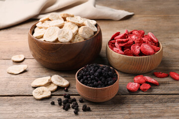 Bowls and dried fruits on wooden table