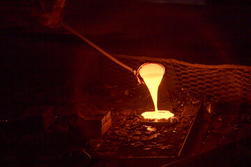 Man worker takes sample of cast iron.