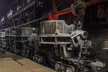 Slag carrier wagon with hot melting slag in container.