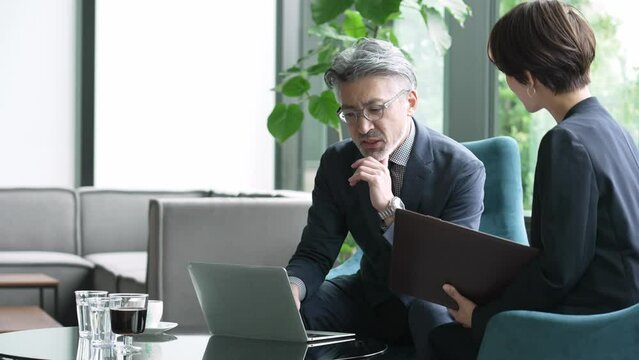 ラウンジで打ち合わせをするビジネスパーソン