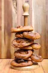 Handmade home stile delicious bagels cooked in the dark warm oven are prepared to be eaten on the wooden cooking stand at the farm kitchen wooden craft texture table. Happy weekend party. 