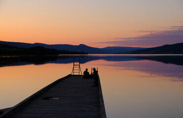Norwegian lake and pier at sunset, silhouette, Jevnaker, Norway