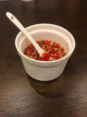 Thai fish sauce with slice chili in a white cup,Include Clipping Path.