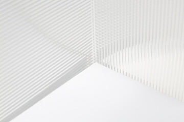 Stripe texture acrylic sheet. Clear linear prismatic panel, extruded linear ribs acrylic sheet. Abstract minimal graphic design resource.
Close up of clear transparent plexiglass.