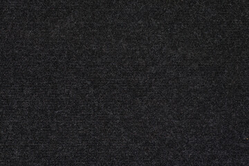 texture and full-frame macro background of black synthetic car carpet.