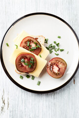 Sandwich with cheese and tomatoes. Bright wooden background. Top view. Copy space.