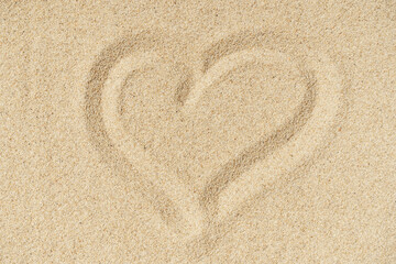 Heart sand beach texture background. Light hot sand on the sea coast in summer. Travel, relax, vacation concept
