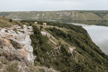 Houses on the banks of a large river with calm water. Bakota Bay rural view. The landscape of Dniester river, Ukraine.