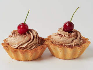 cake basket with cream and cherries on a plate