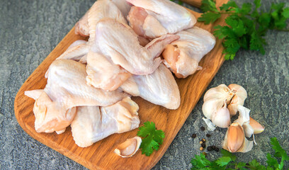 Raw meat chicken wings on a board. Selective focus.