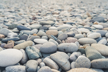 Dry pebbles and stones in soft colors creating an abstract composition. Wallpaper idea. High quality photo