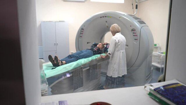 Young female patient lying on a ct or mri scan bed during medical exam	