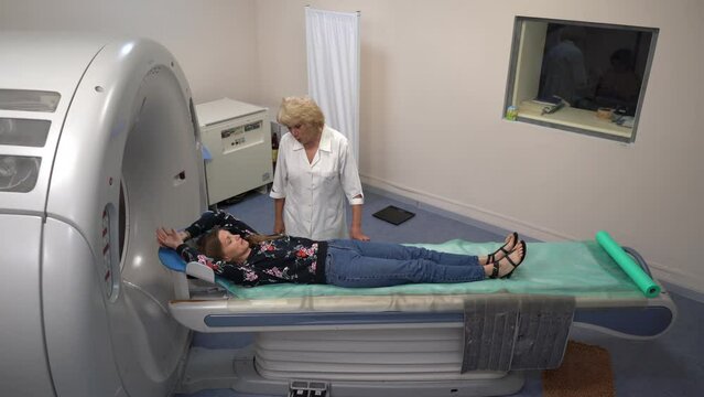Young female patient lying on a ct or mri scan bed during medical exam