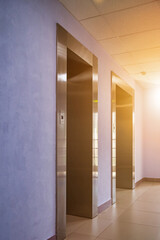 Background of interior floor of elevator platform with elevators and sunlight in business center
