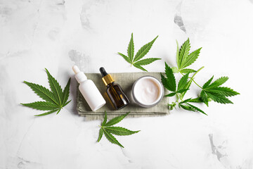 Obraz na płótnie Canvas Hemp cannabis leaves and beauty products