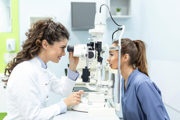 Eye doctor with female patient during an examination in modern clinic. Ophthalmologist is using special medical equipment for eye health