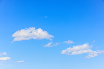 A scenic view of a majestic blue sky with some white clouds