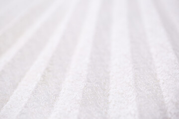 White fabric pleated with lace as a background. Lightweight summer clothing material, patterned texture. Wedding Dress.